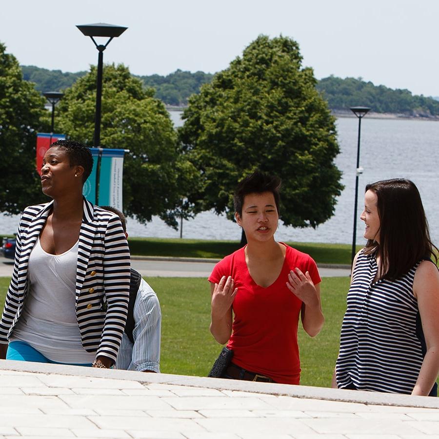 Students walk and talk with each other on stairs outside the Campus Center.